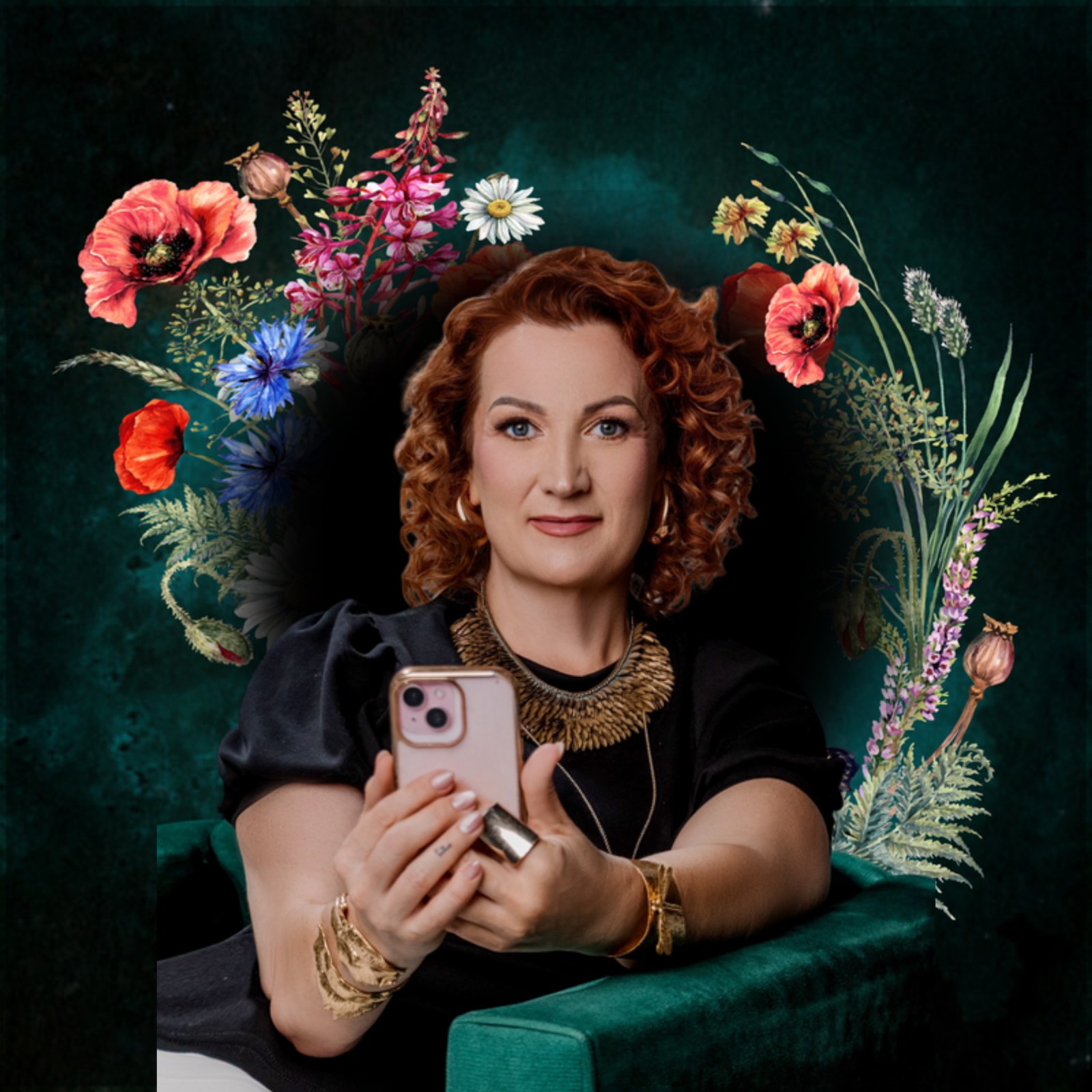 Kelly Diels, red hair, holding her phone, surrounded by florals